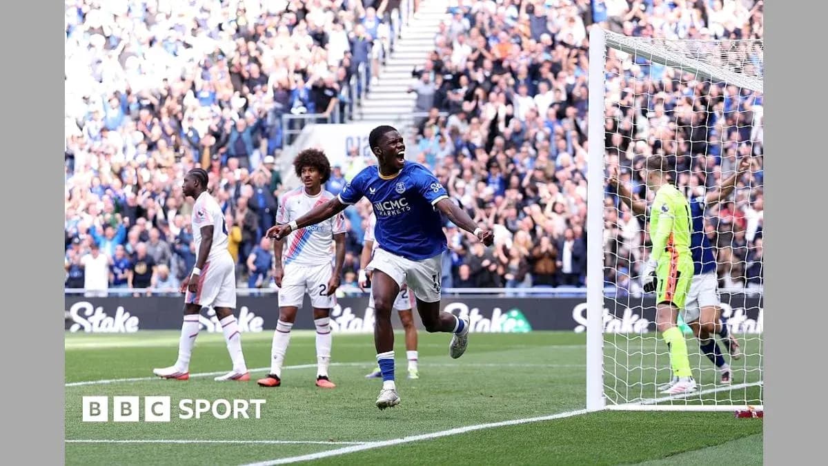 Player celebrating a goal with fans in background Player celebrating a goal with fans in background