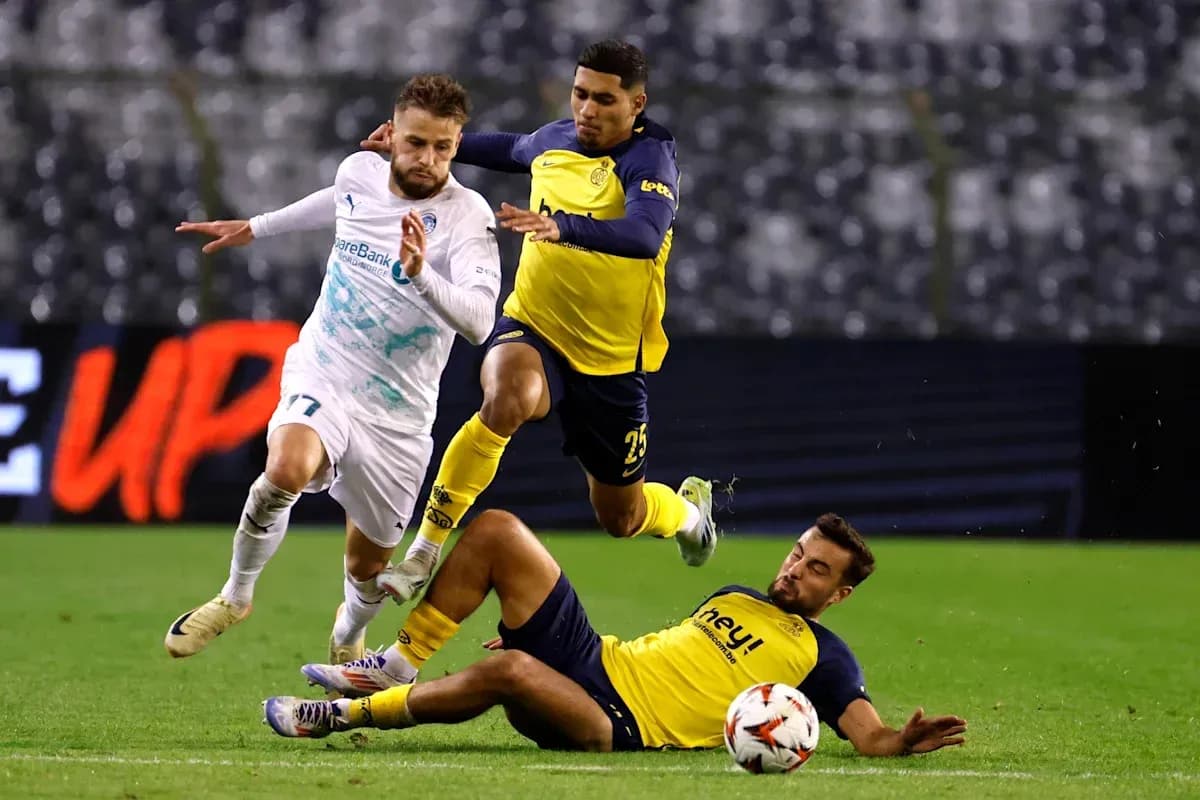 Player attempting to evade two defenders on field Player attempting to evade two defenders on field