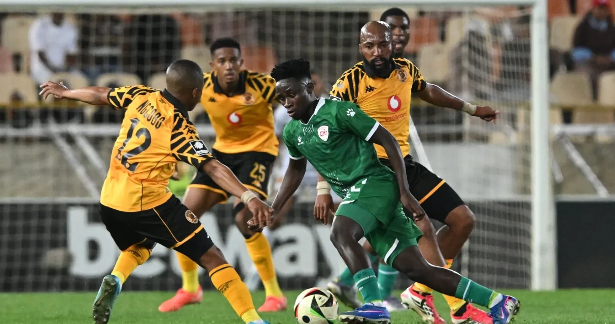 Players competing for the ball during a football match Players competing for the ball during a football match
