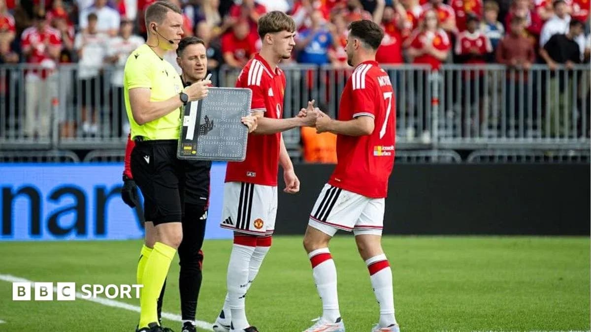 Players shaking hands during a substitution in match Players shaking hands during a substitution in match