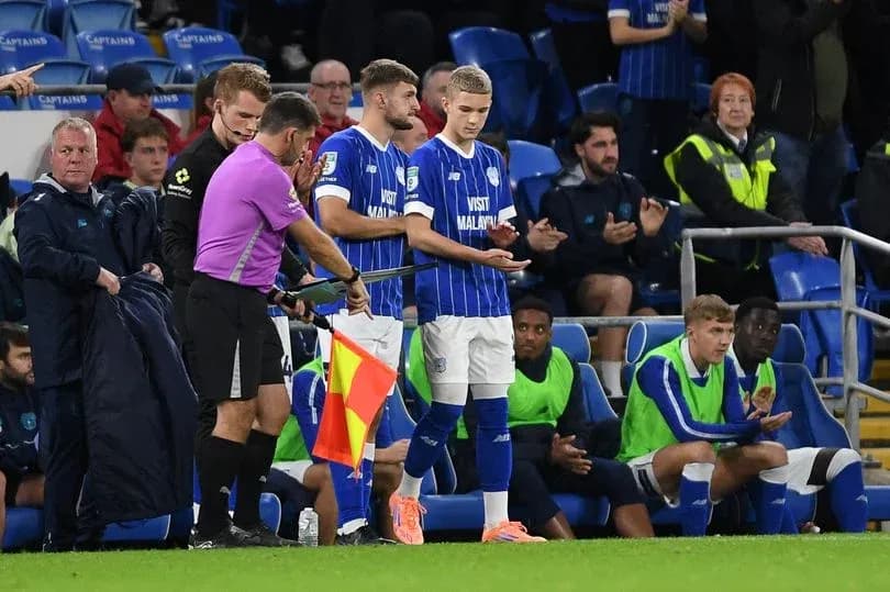 Player substitution during football match on sidelines Player substitution during football match on sidelines