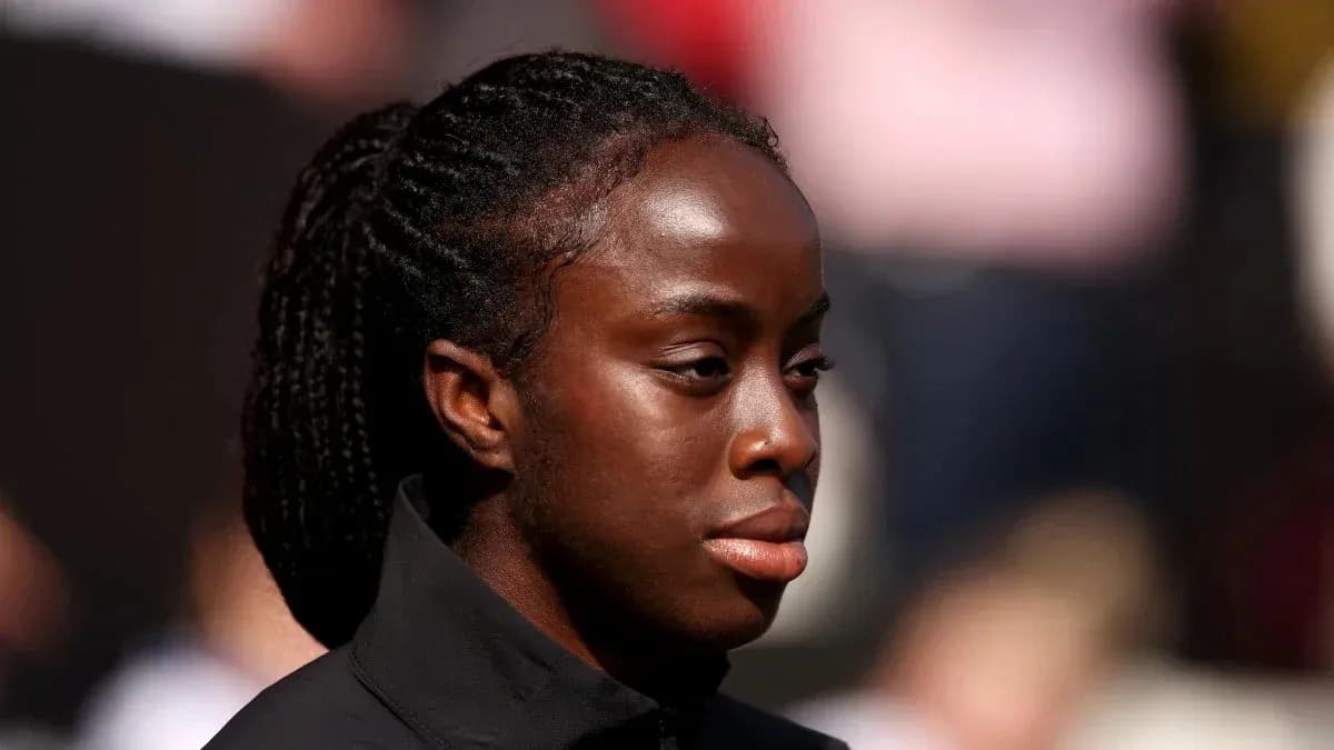 Athlete with braided hair looking focused before event Athlete with braided hair looking focused before event