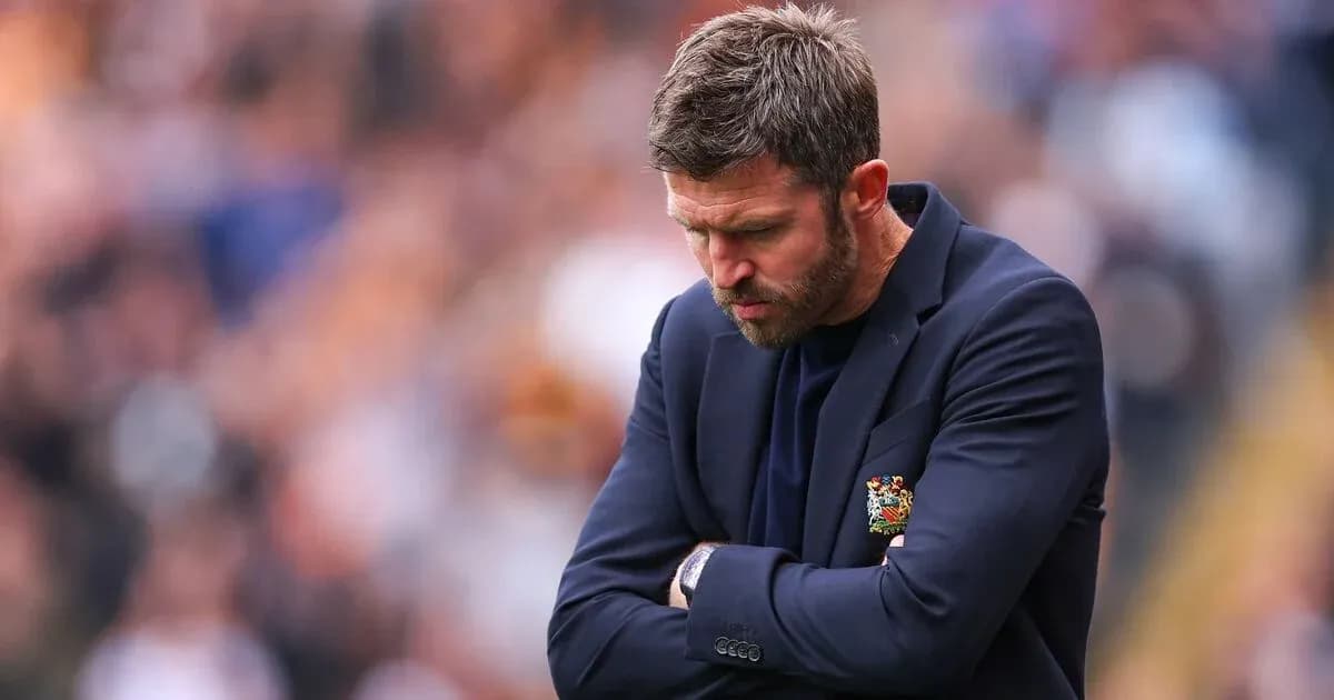Manager looking down with arms crossed during match Manager looking down with arms crossed during match