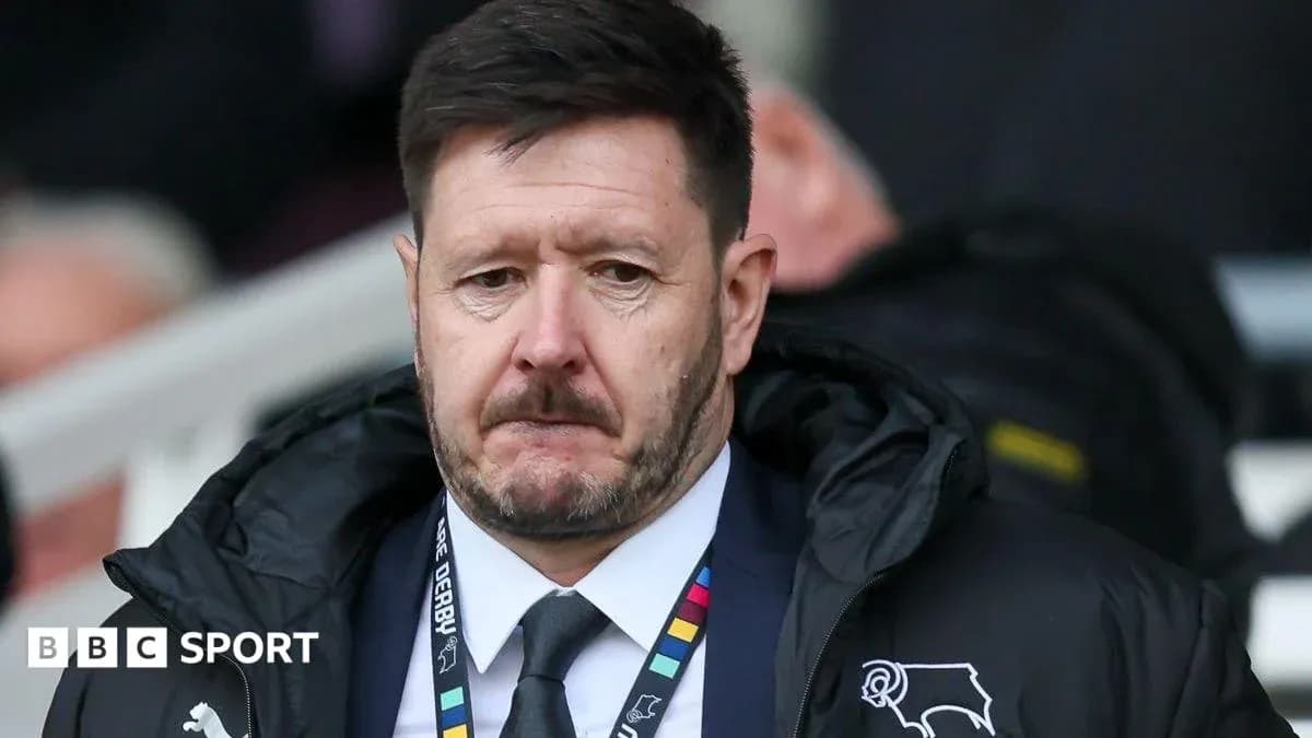 Manager wearing team jacket during match Manager wearing team jacket during match