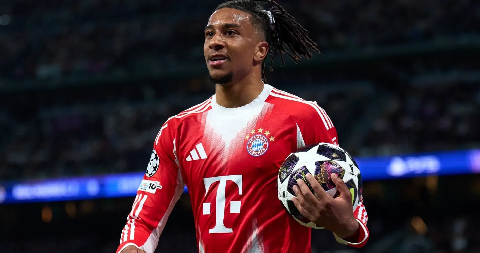 Player holding a Champions League ball on pitch Player holding a Champions League ball on pitch