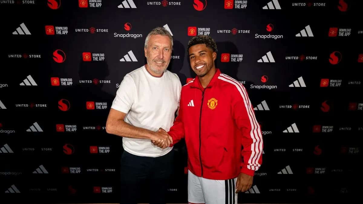 Two men shaking hands at a Manchester United event Two men shaking hands at a Manchester United event