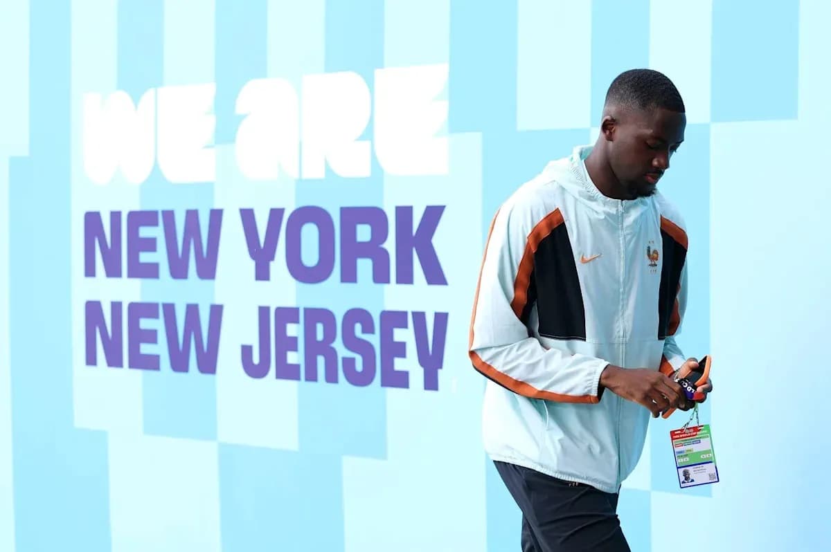 Player walking by wall with 'We Are New York New Jersey' text Player walking by wall with 'We Are New York New Jersey' text