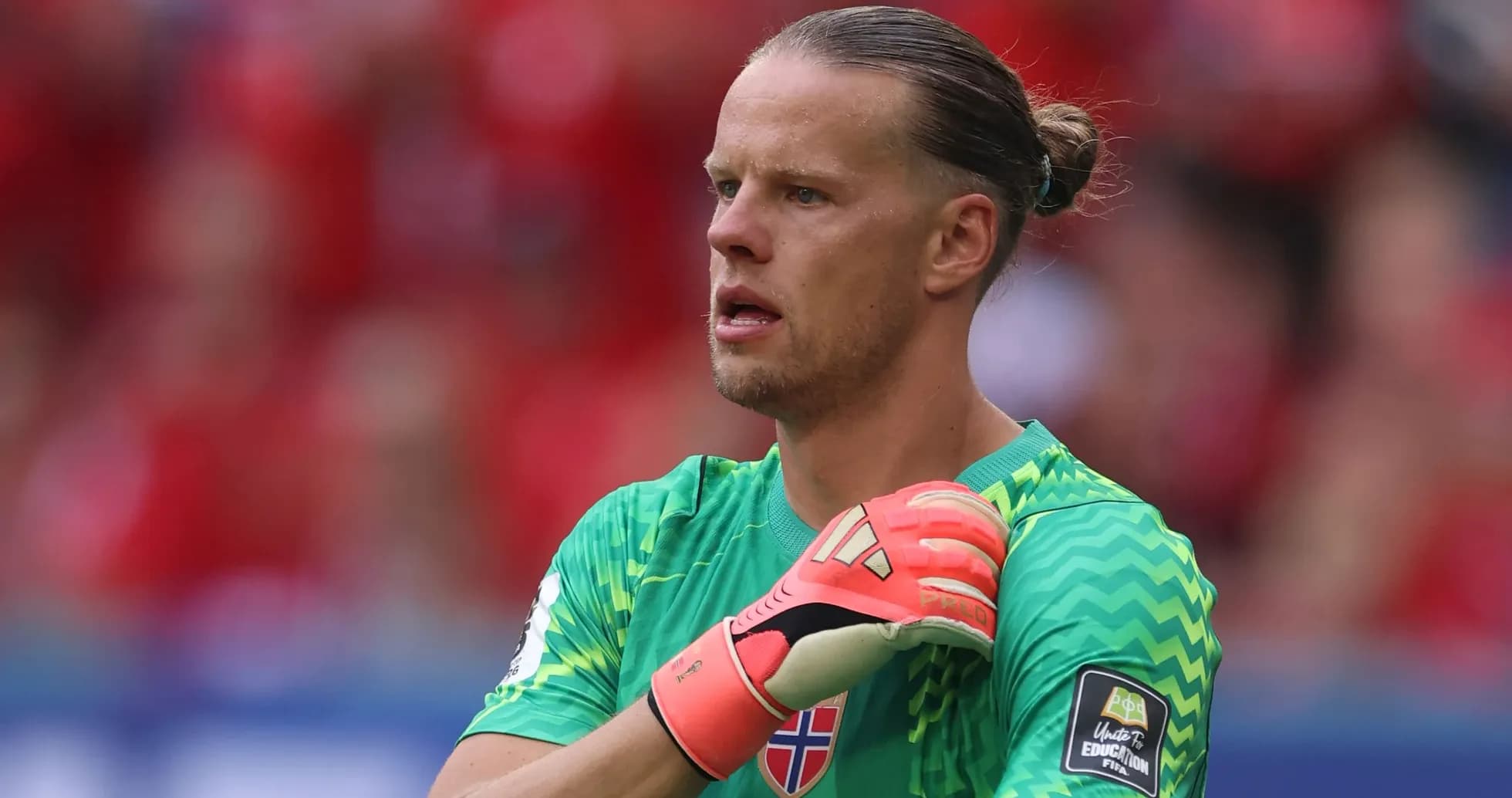 Goalkeeper adjusting gloves during a match Goalkeeper adjusting gloves during a match