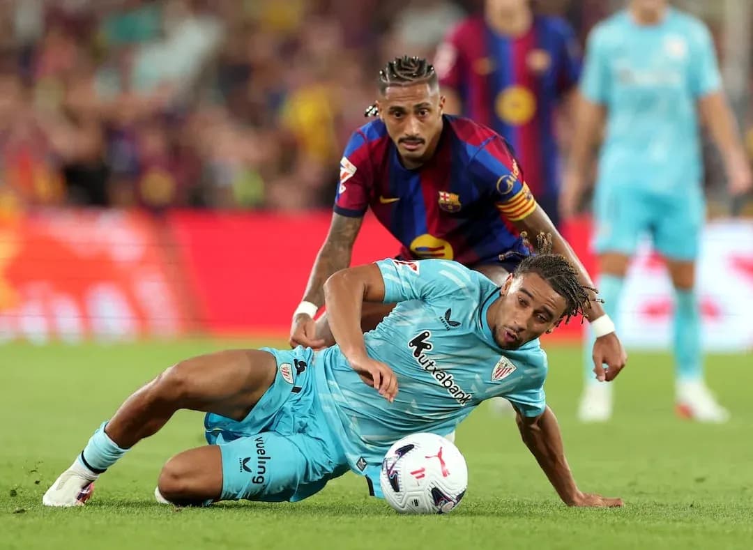 Player tackling on the field during La Liga match Player tackling on the field during La Liga match