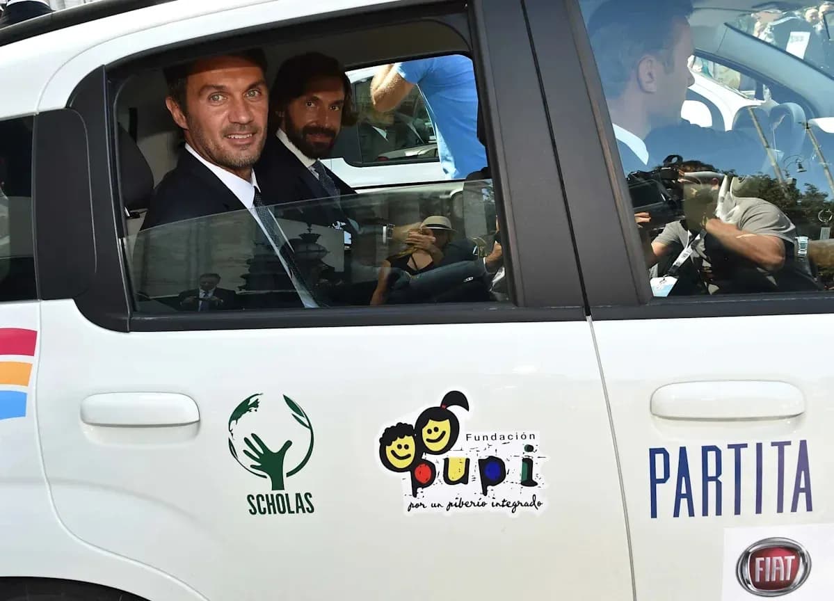 Two men in a car with charity logos Two men in a car with charity logos