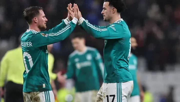 Two players celebrating with high-fives on field Two players celebrating with high-fives on field