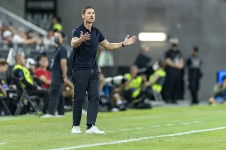 Coach gesturing during a soccer match on the sidelines Coach gesturing during a soccer match on the sidelines