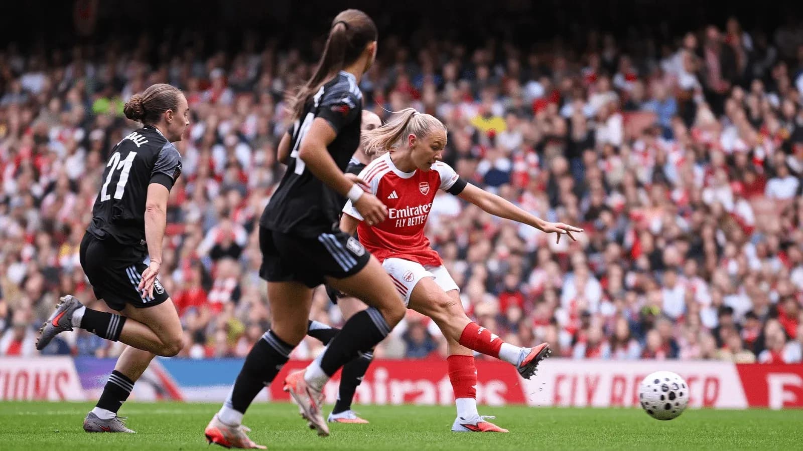 Arsenal player taking a shot on goal Arsenal player taking a shot on goal