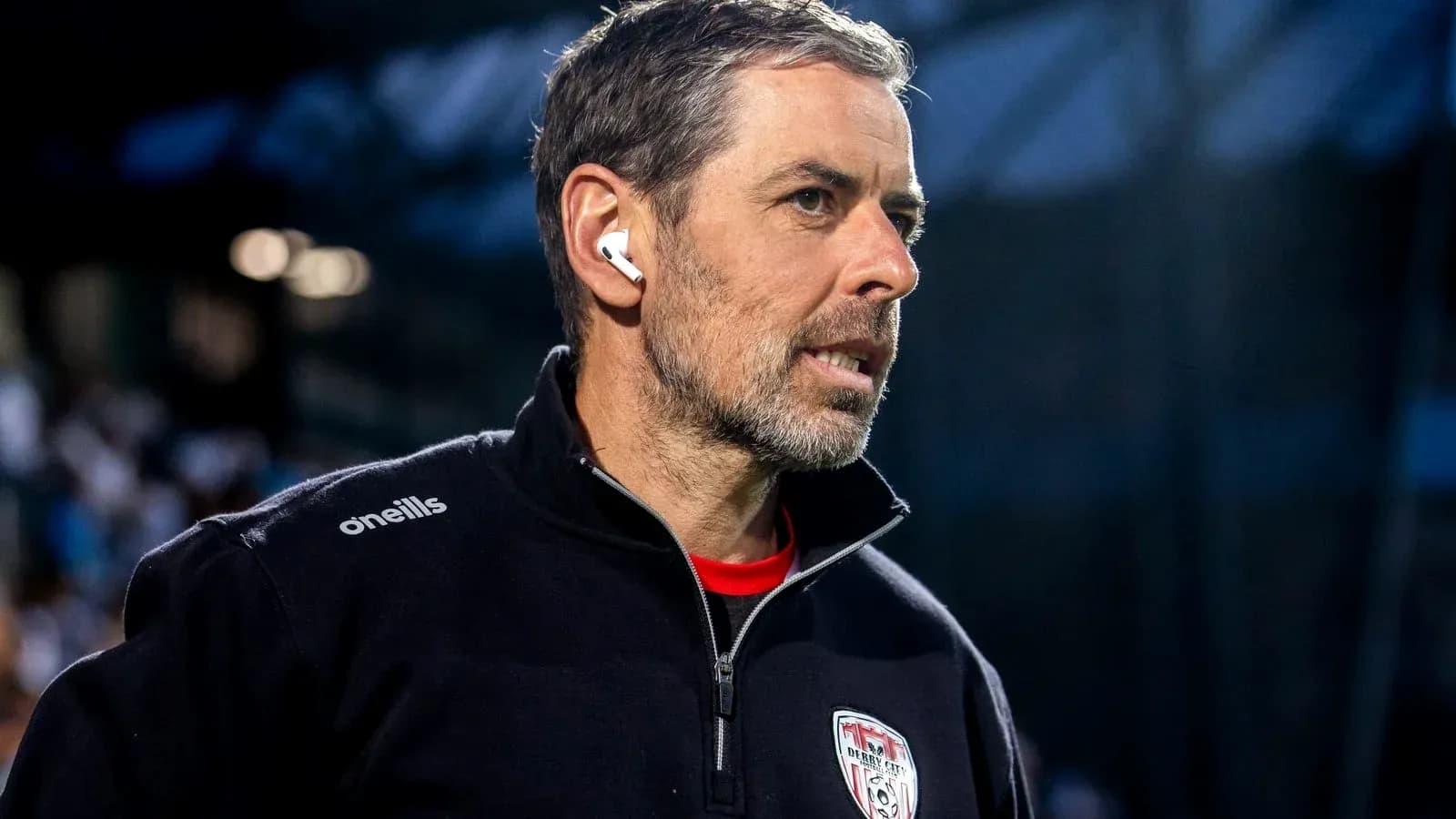 Coach wearing headphones during match preparations Coach wearing headphones during match preparations