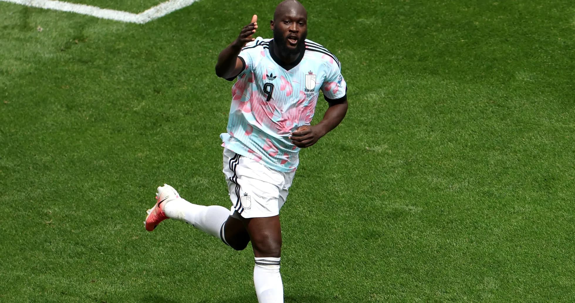 Player celebrating after scoring a goal on pitch Player celebrating after scoring a goal on pitch