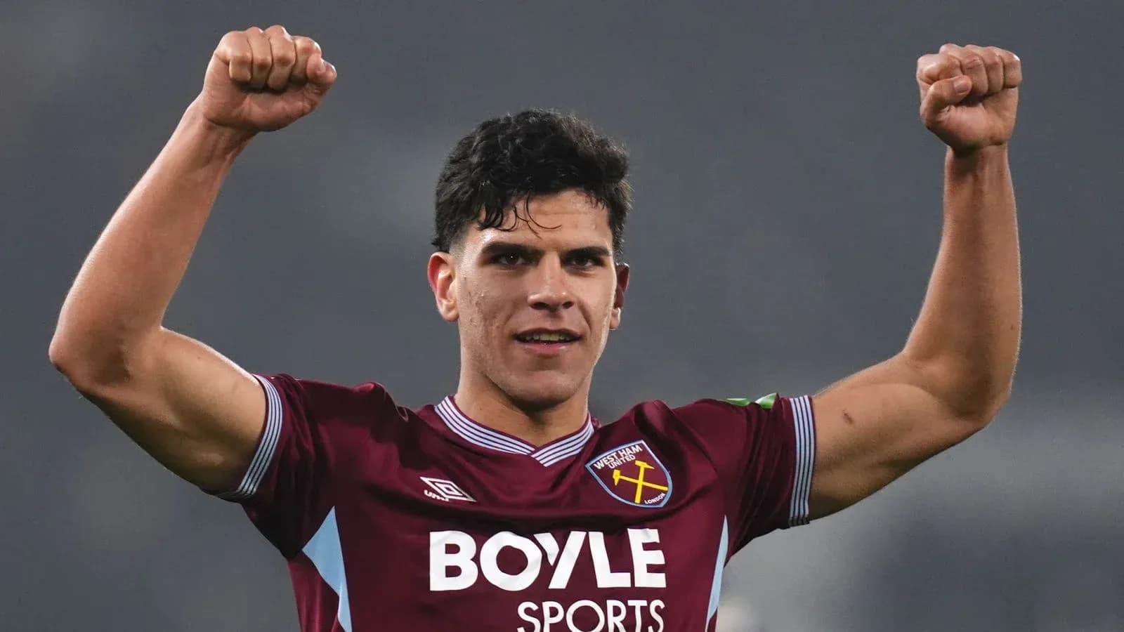 Player celebrating with raised fists in West Ham kit Player celebrating with raised fists in West Ham kit