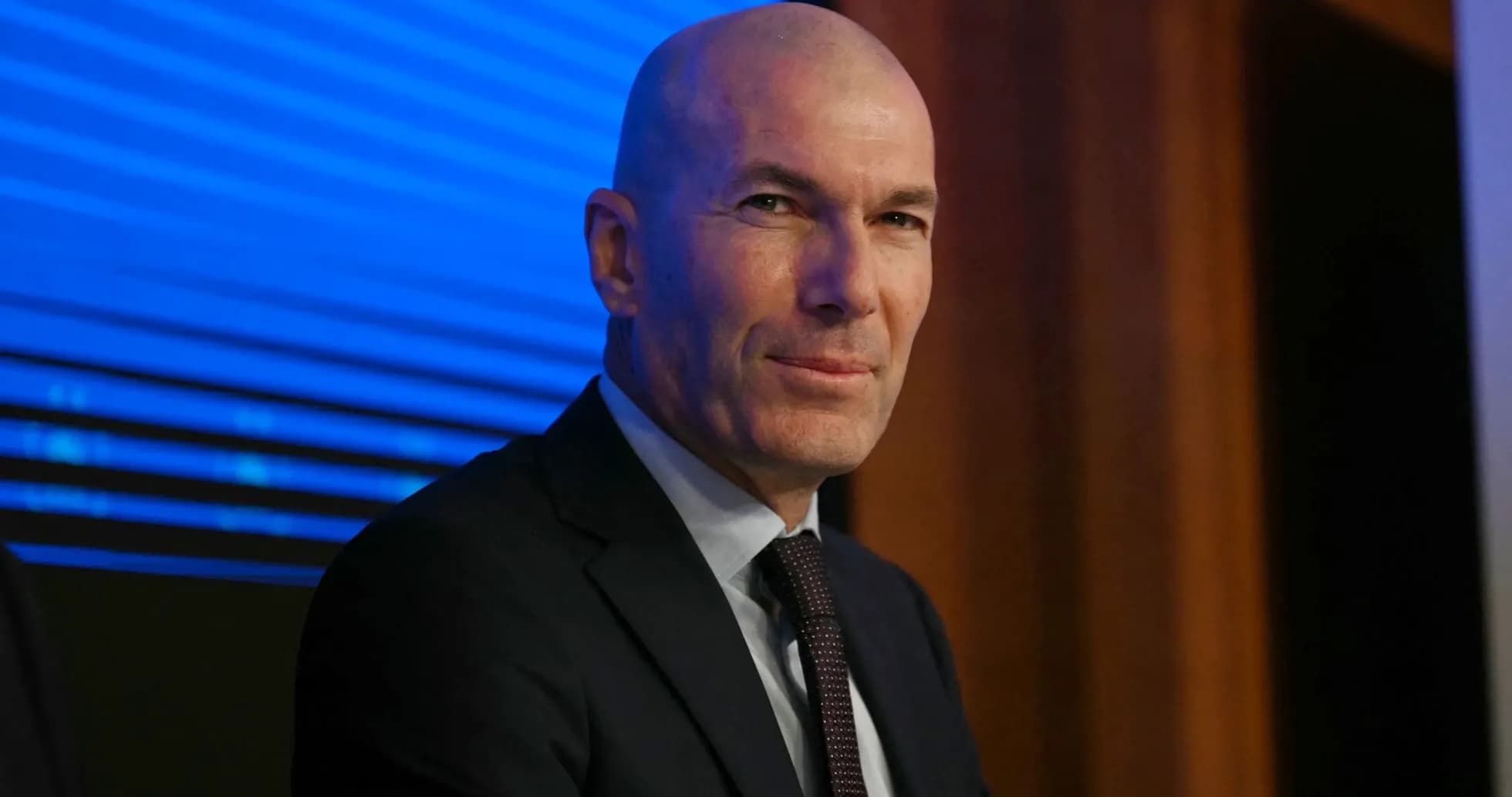 Bald man in suit at press conference Bald man in suit at press conference