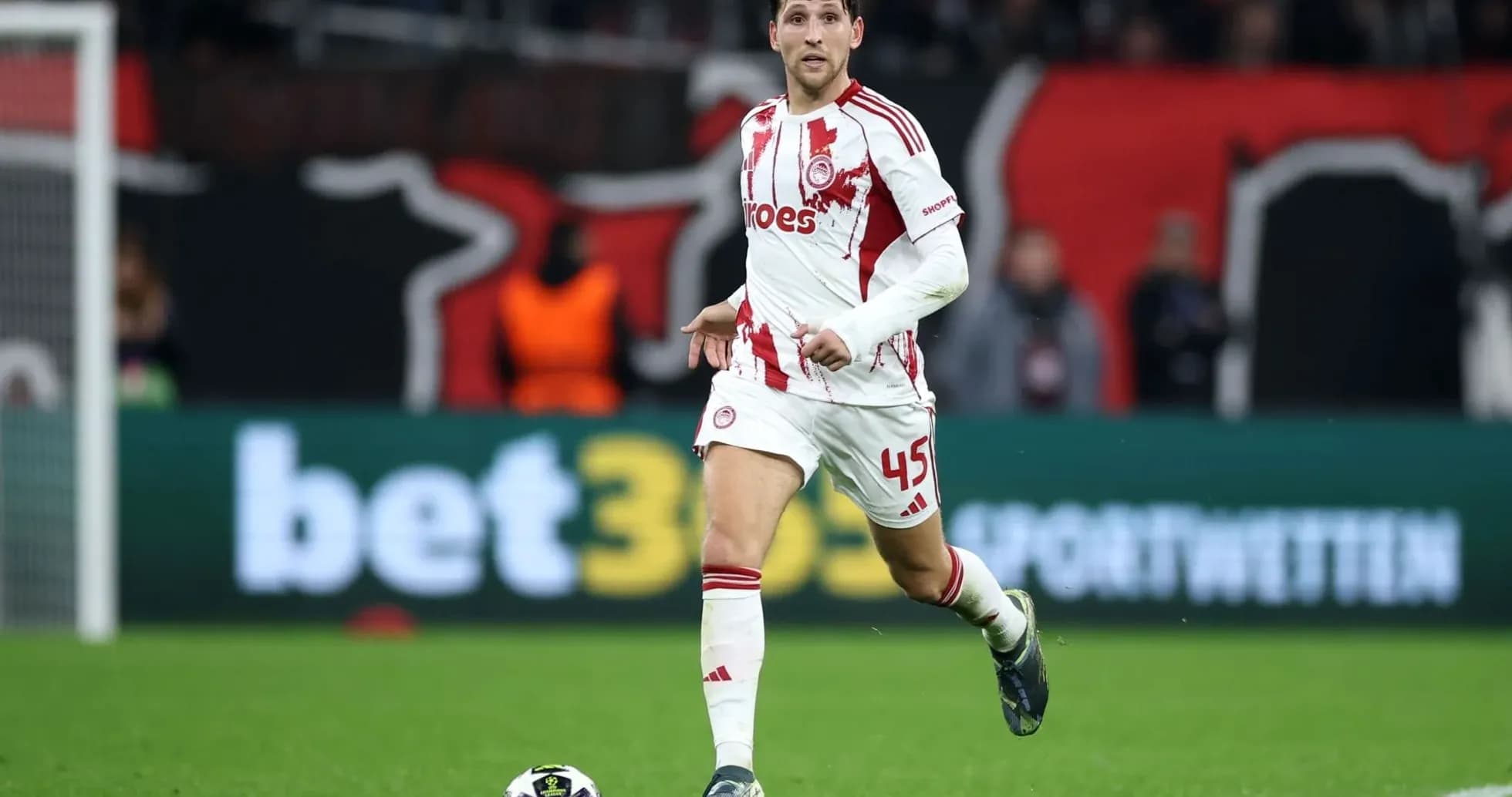 Olympiakos player dribbling the ball during match Olympiakos player dribbling the ball during match