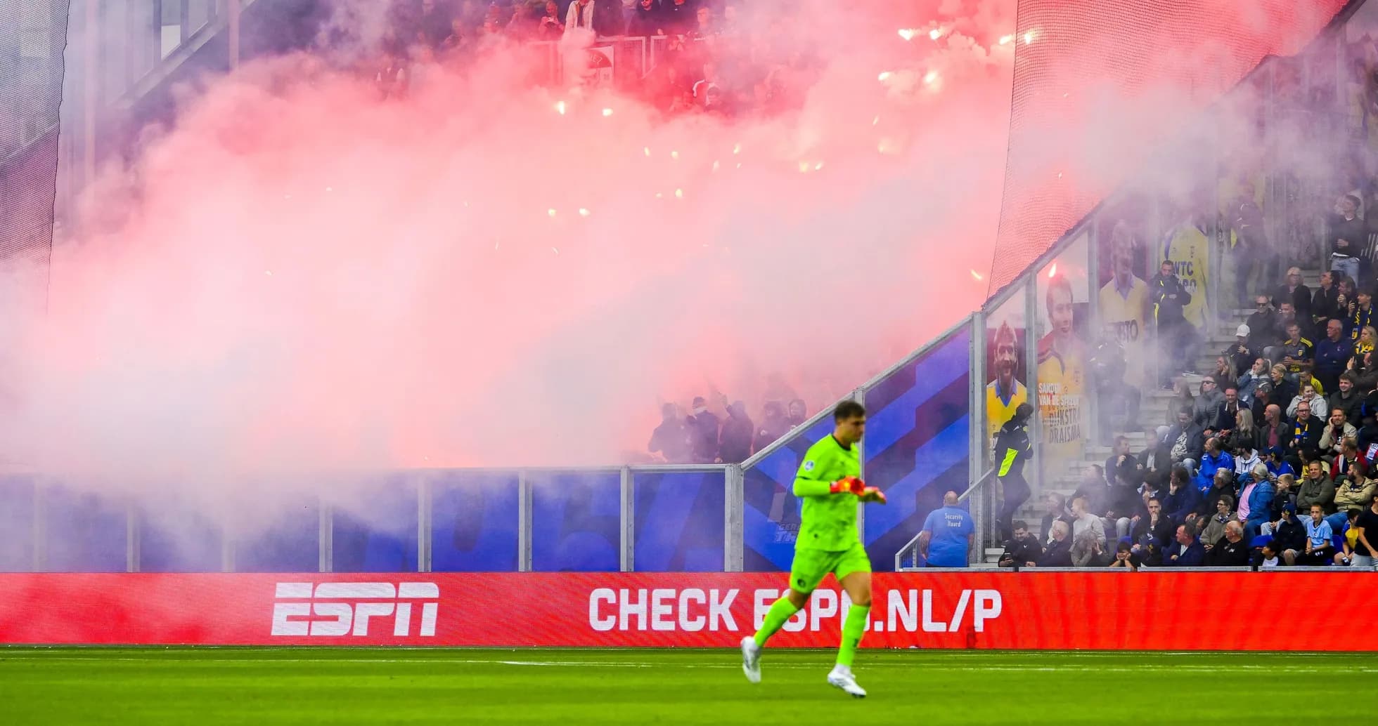 Goalkeeper walking past smoke and flares during match Goalkeeper walking past smoke and flares during match