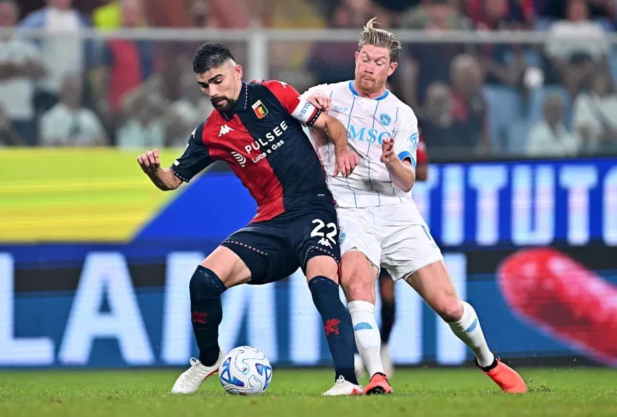 Genoa player challenged by Napoli player during match Genoa player challenged by Napoli player during match