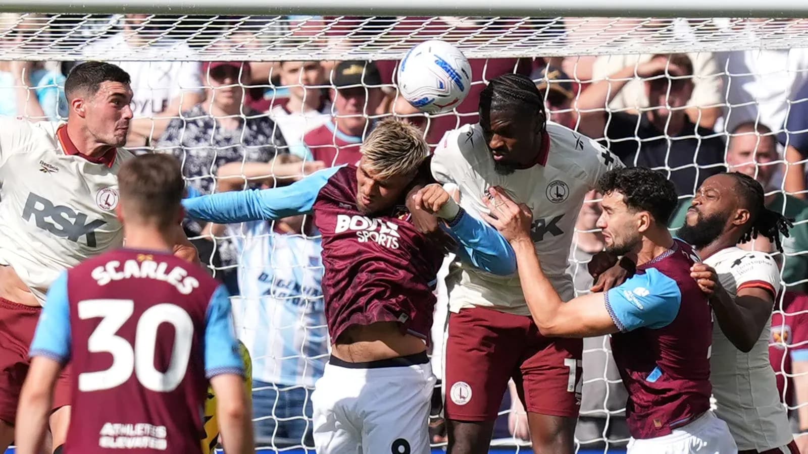 Players contesting a header near the goal line Players contesting a header near the goal line