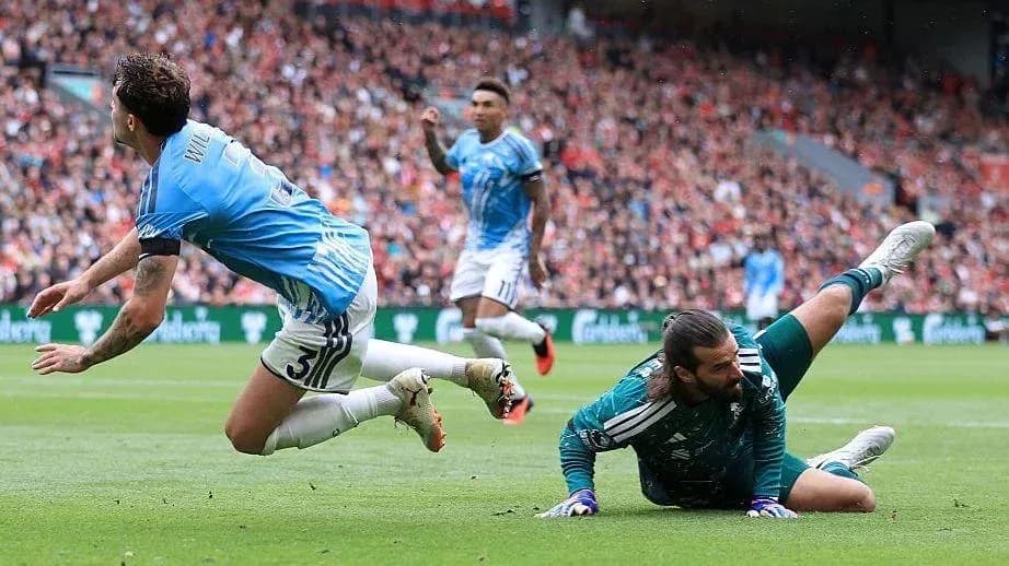 Player falling as goalkeeper makes a save Player falling as goalkeeper makes a save