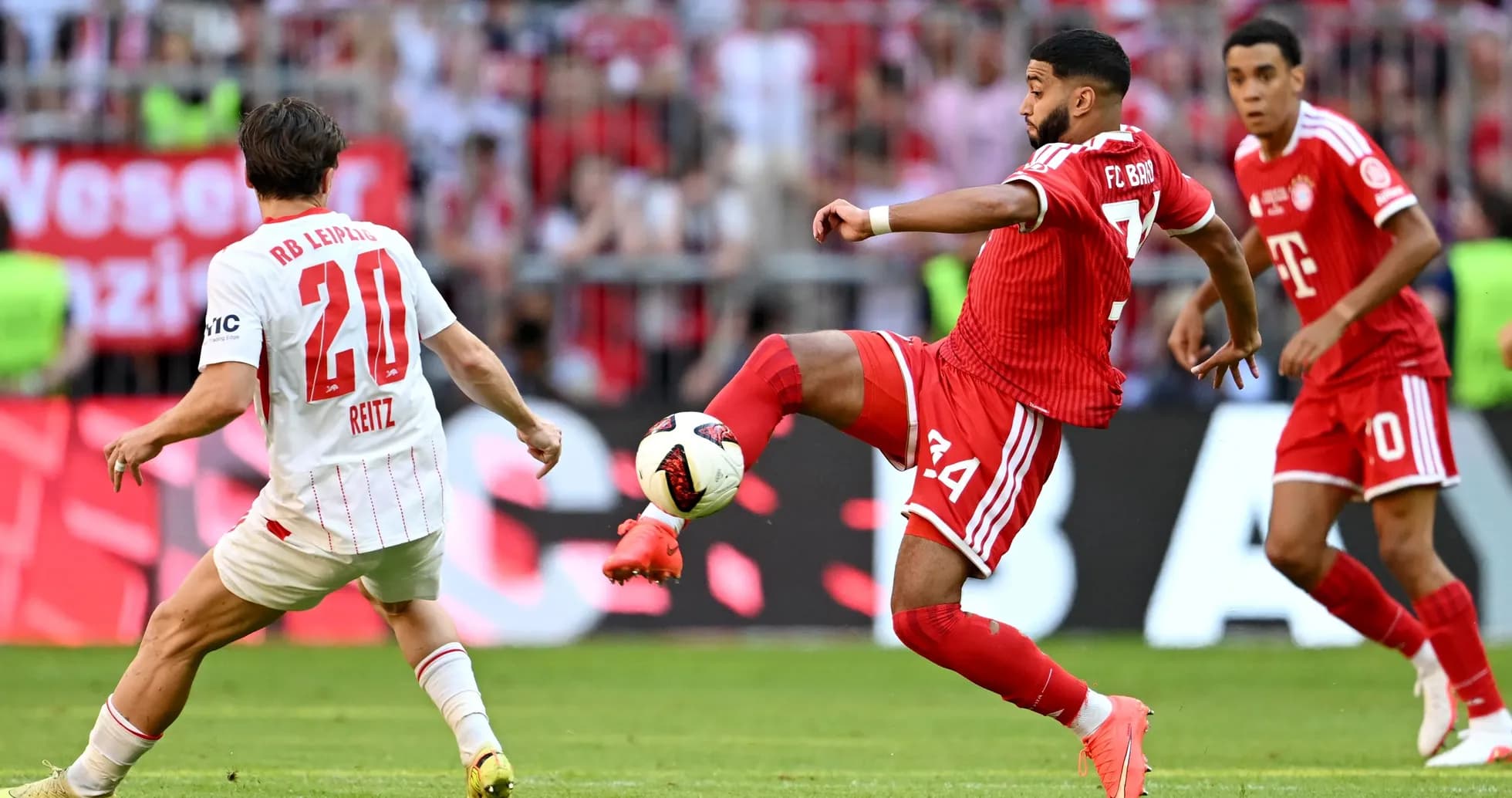 FC Bayern player kicking ball against RB Leipzig player FC Bayern player kicking ball against RB Leipzig player
