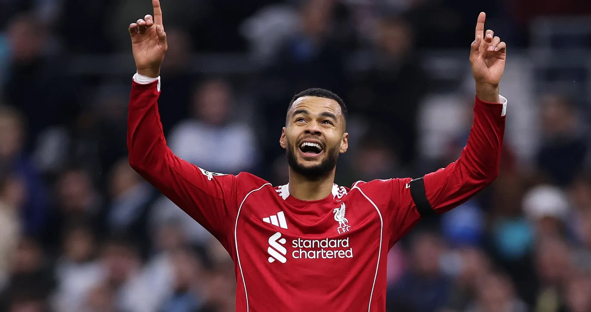Player celebrating with arms raised after a goal Player celebrating with arms raised after a goal