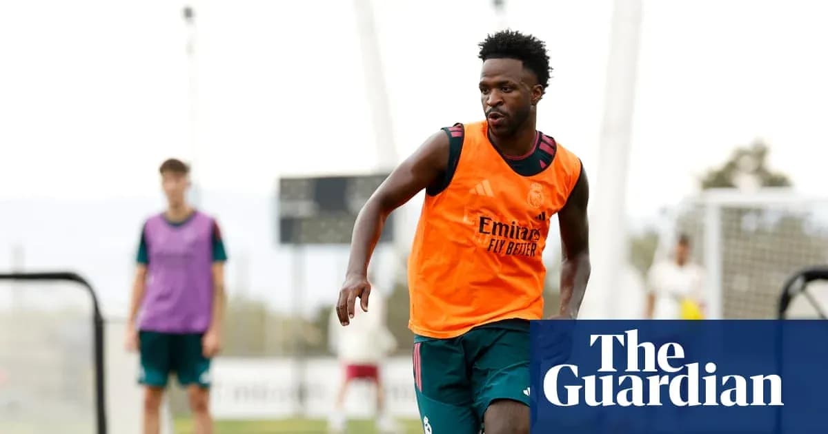 Player in orange training bib running during practice Player in orange training bib running during practice
