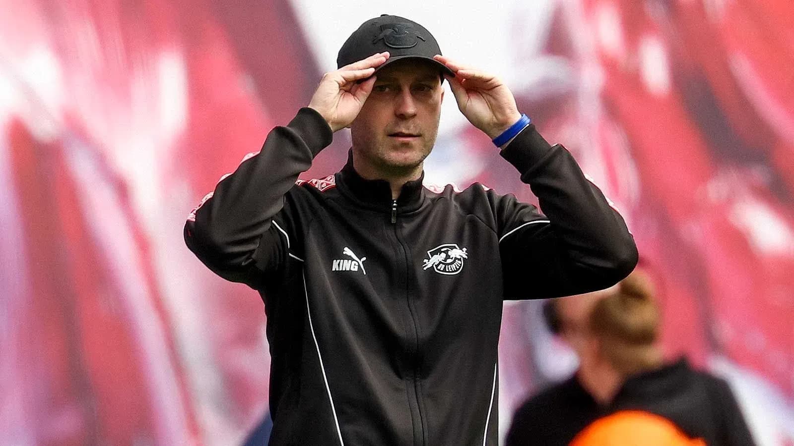 Coach adjusting cap during match on the sidelines Coach adjusting cap during match on the sidelines