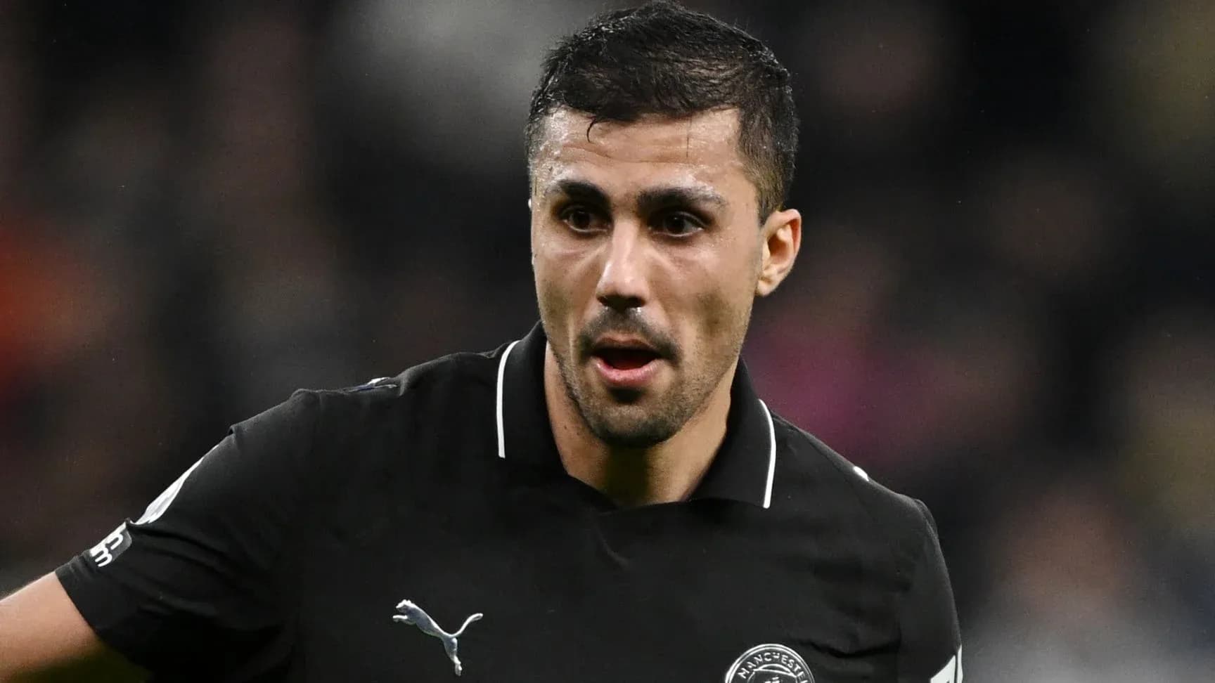 Player in black jersey during a match Player in black jersey during a match