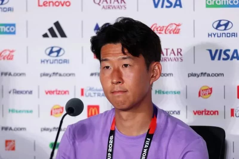 Player at press conference with sponsors' logos behind Player at press conference with sponsors' logos behind