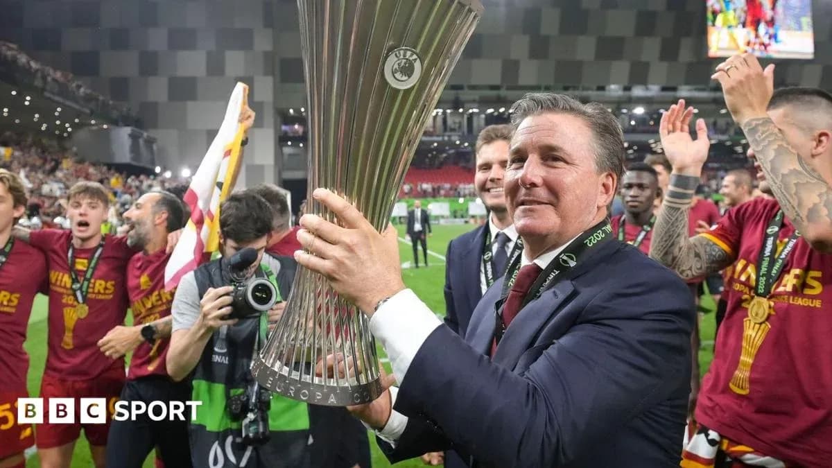 Coach celebrating with UEFA Europa League trophy Coach celebrating with UEFA Europa League trophy