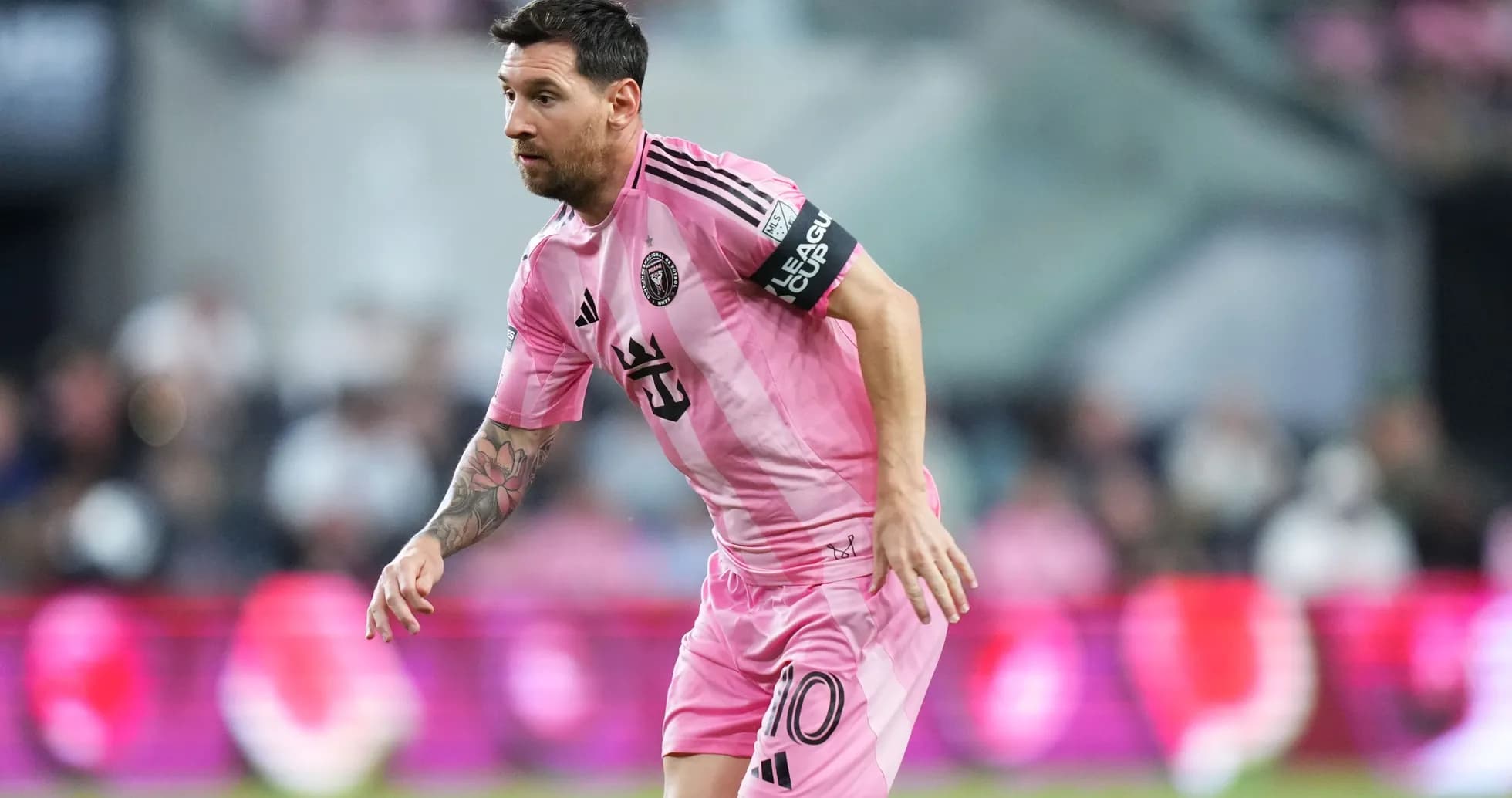 Lionel Messi in pink Inter Miami jersey on field Lionel Messi in pink Inter Miami jersey on field