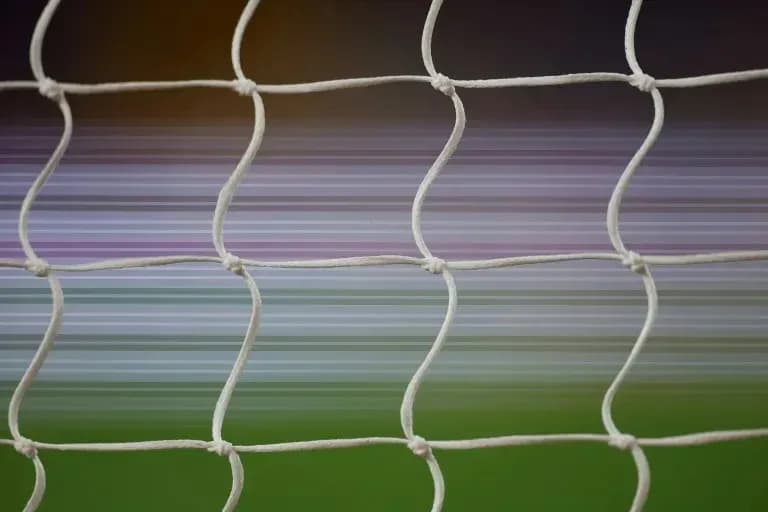 Close-up of soccer goal net with blurred background Close-up of soccer goal net with blurred background