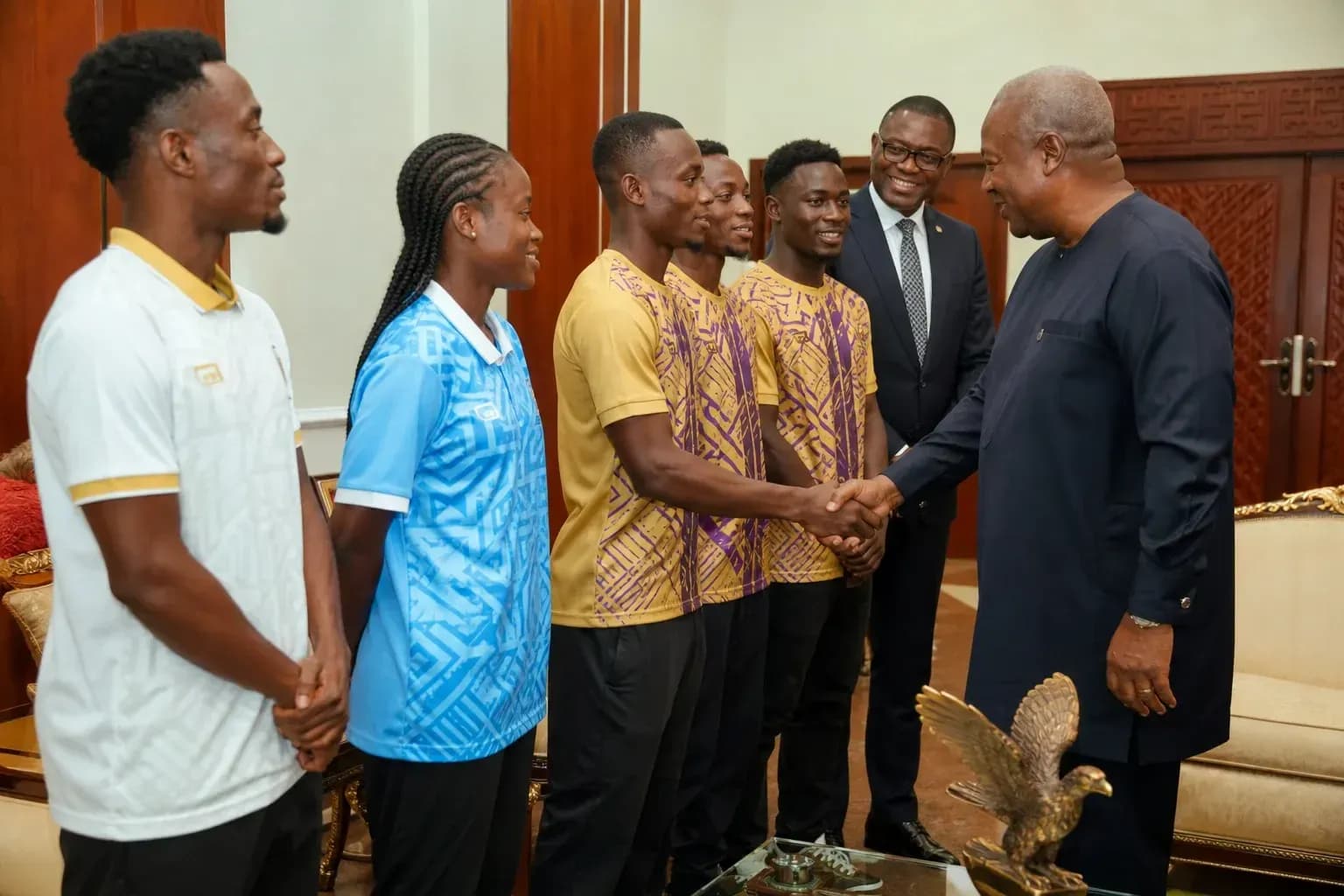 Athletes shaking hands with a dignitary in office Athletes shaking hands with a dignitary in office