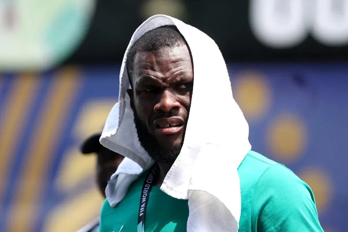 Player with towel on head during warm-up Player with towel on head during warm-up