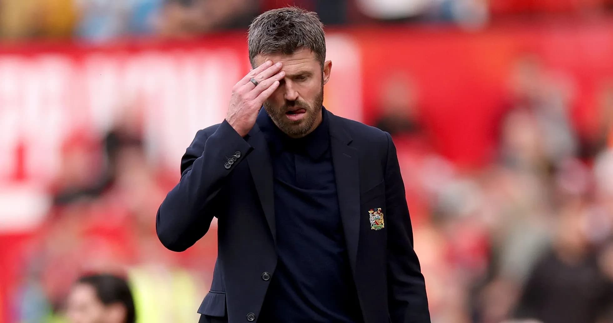 Coach walking with hand on forehead during match Coach walking with hand on forehead during match