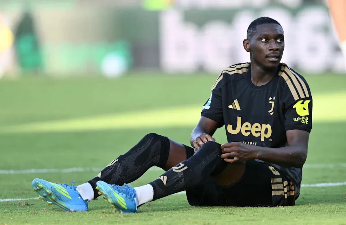Player sitting on field wearing Juventus kit Player sitting on field wearing Juventus kit