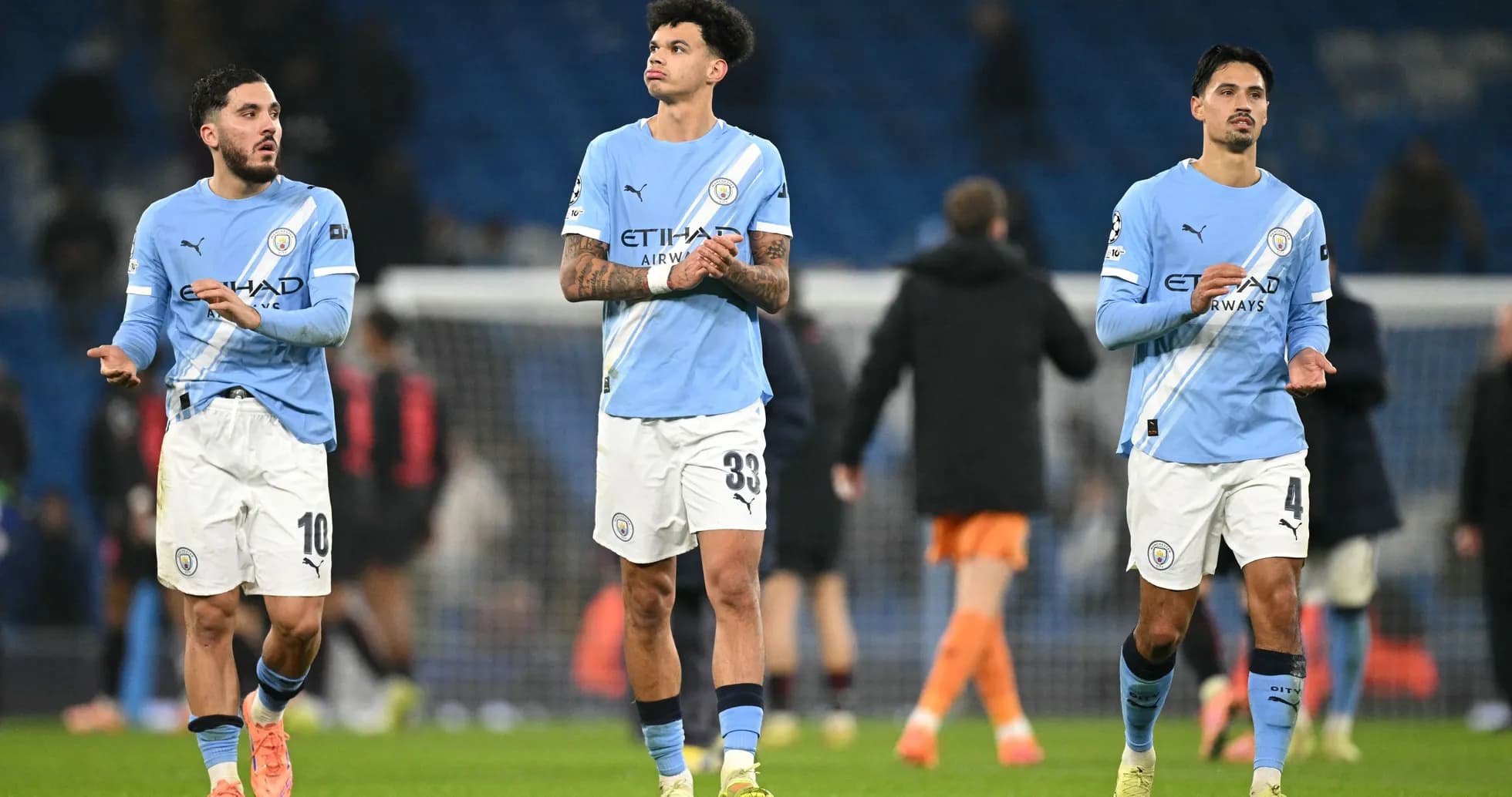 Three Manchester City players walking off the pitch Three Manchester City players walking off the pitch