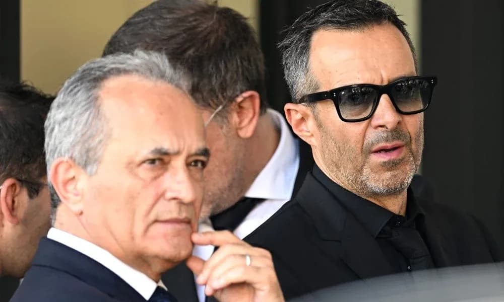 Two men in formal attire with sunglasses outdoors Two men in formal attire with sunglasses outdoors
