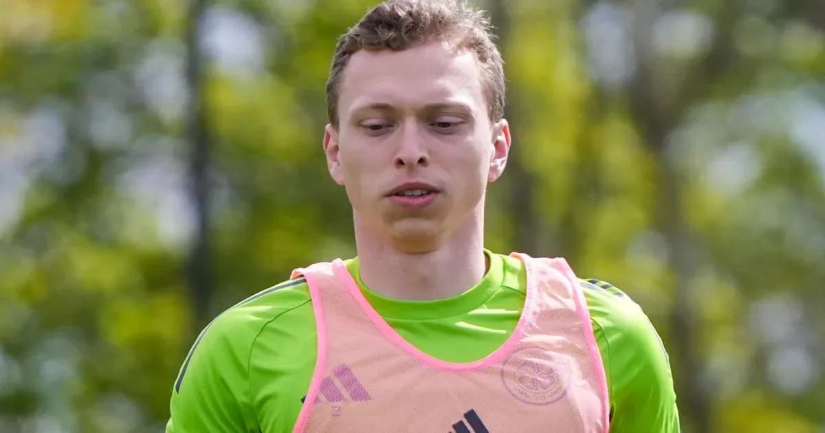 Goalkeeper training in a green jersey and pink bib Goalkeeper training in a green jersey and pink bib