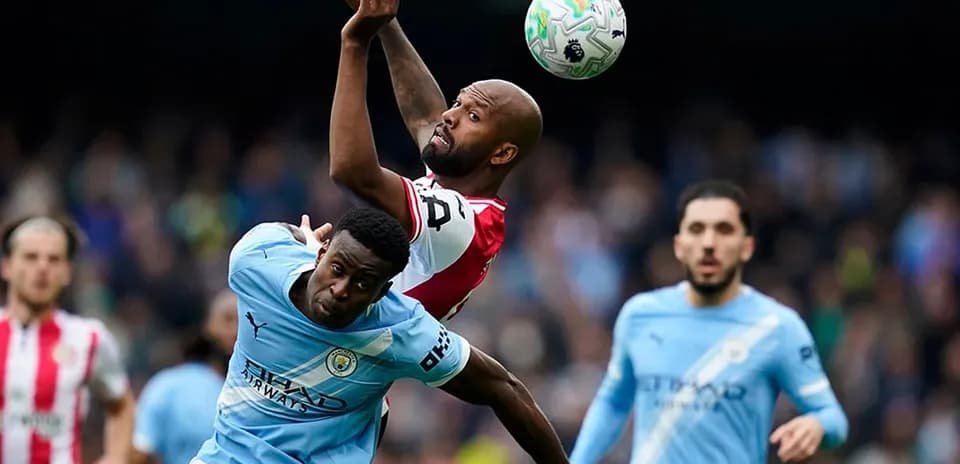 Manchester City player challenging for the ball Manchester City player challenging for the ball