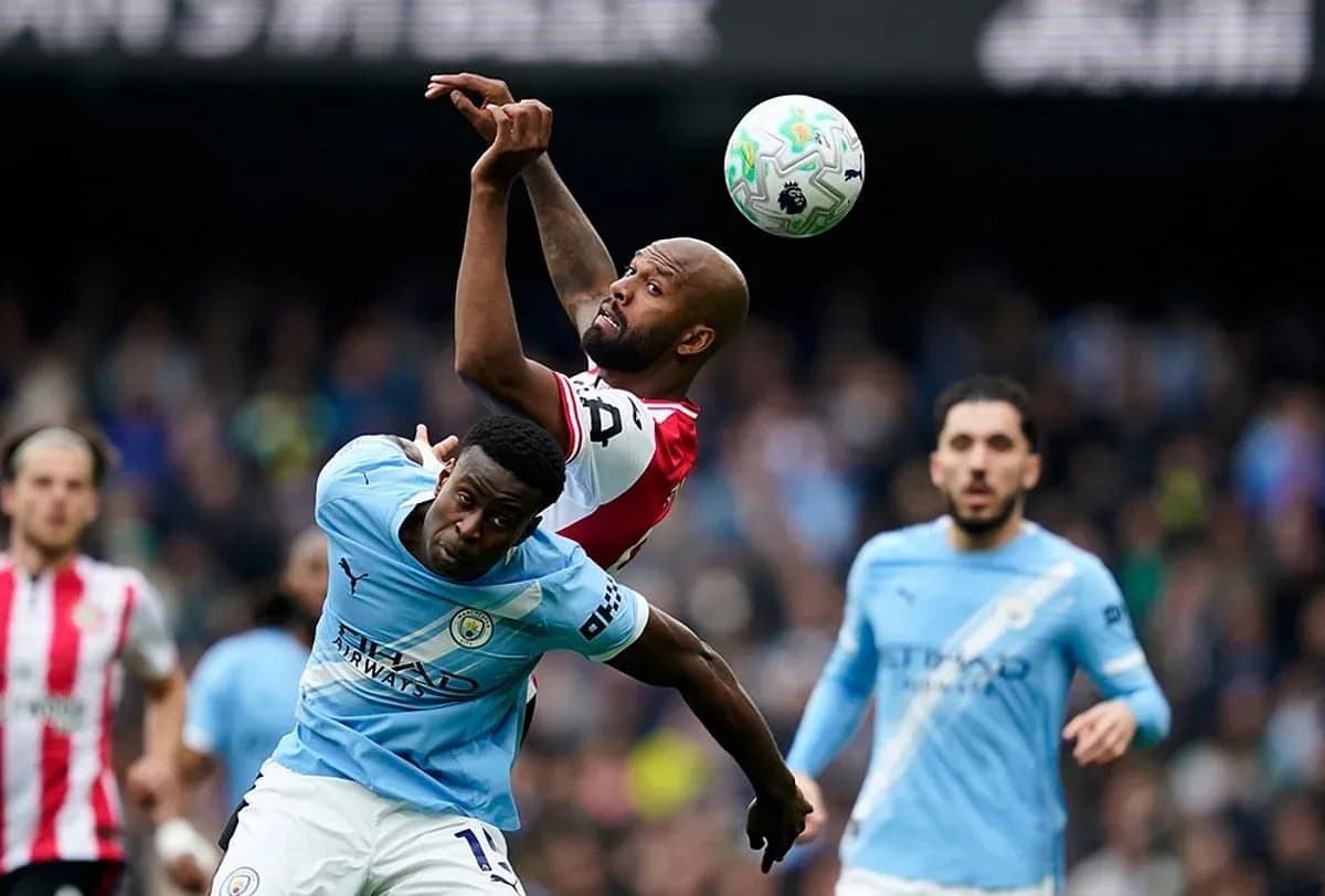 Manchester City player challenging for the ball Manchester City player challenging for the ball