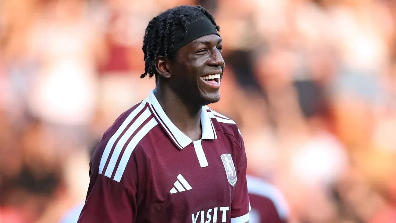 Player smiling during match in maroon jersey Player smiling during match in maroon jersey