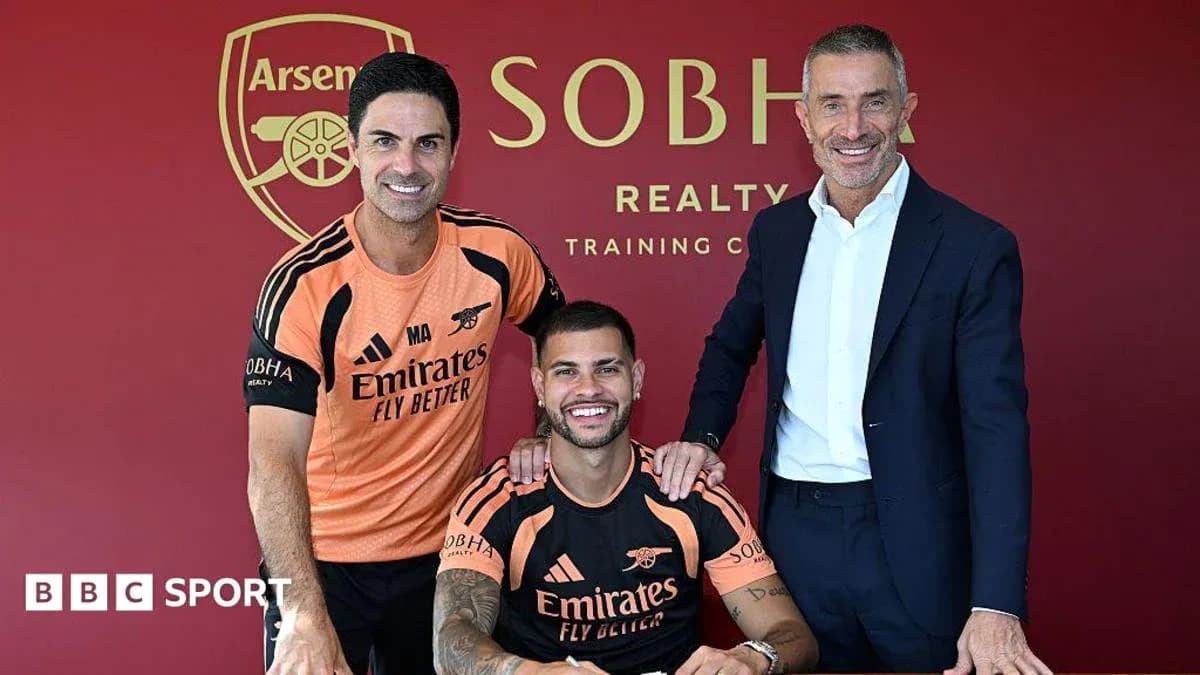 Manager and player signing contract at training facility Manager and player signing contract at training facility