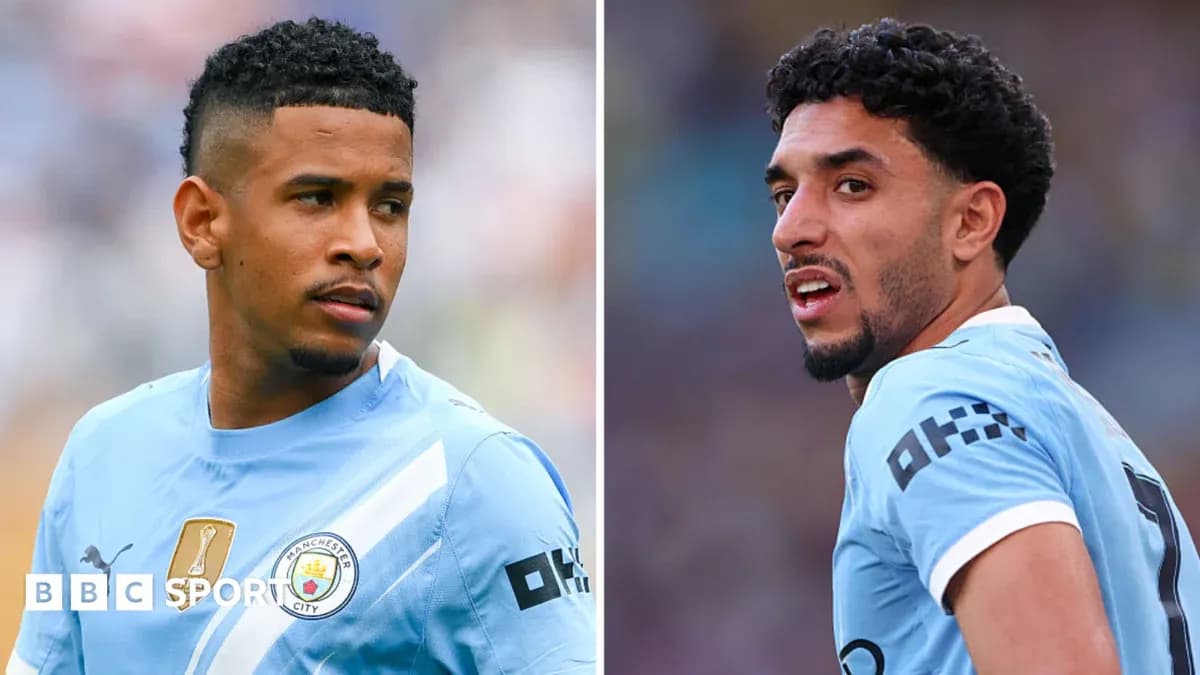 Two Manchester City players in match uniforms Two Manchester City players in match uniforms