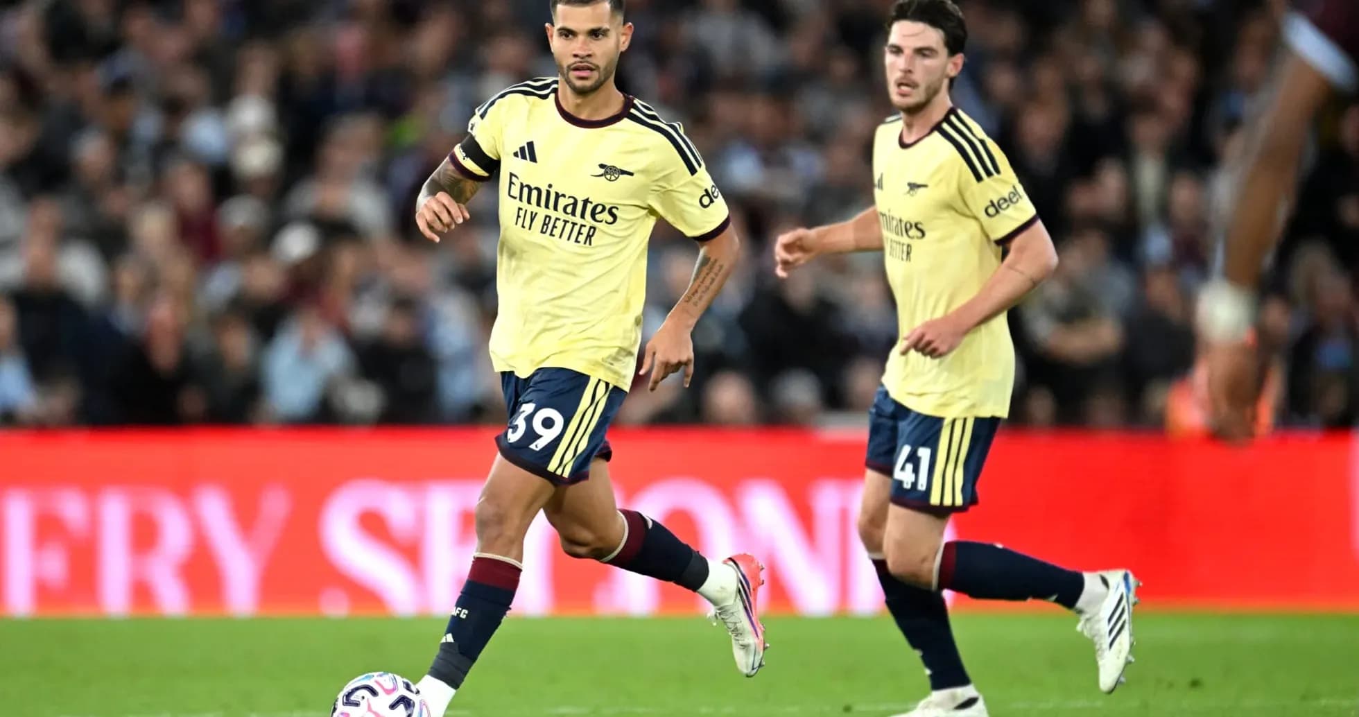 Two Arsenal players in yellow kits during match Two Arsenal players in yellow kits during match