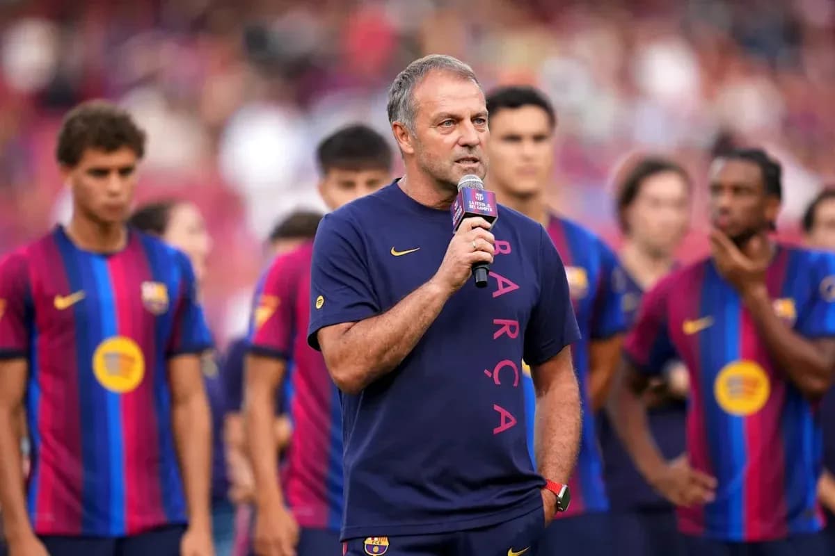 Coach speaking at event with Barcelona players behind Coach speaking at event with Barcelona players behind