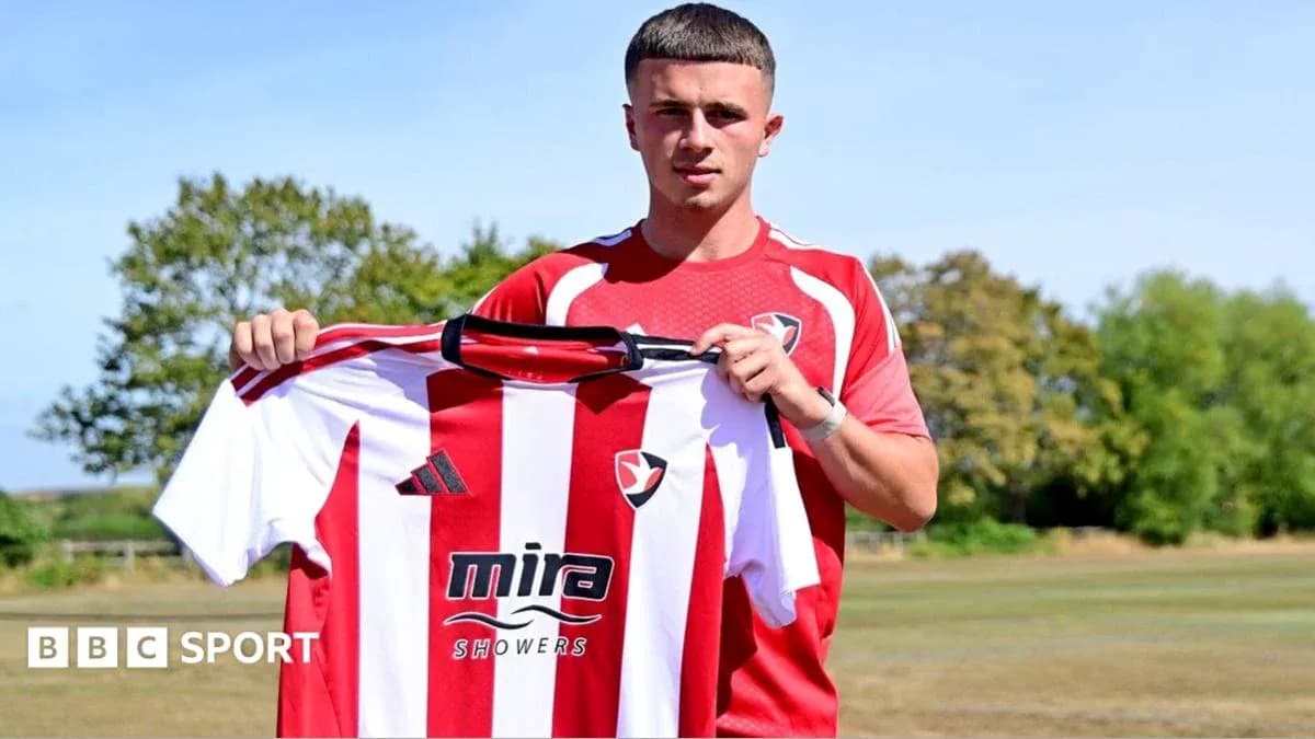 Player holding Cheltenham Town shirt during announcement Player holding Cheltenham Town shirt during announcement